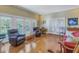 Spacious living room featuring hardwood floors and access to balcony at 7172 Dr Martin Luther King Jr S St, St Petersburg, FL 33705