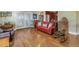 Living room with hardwood floors and a red couch at 7172 Dr Martin Luther King Jr S St, St Petersburg, FL 33705