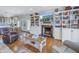 Open living room with hardwood floors, fireplace, and built-in shelving at 7172 Dr Martin Luther King Jr S St, St Petersburg, FL 33705