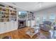 Spacious living room with built-in bookshelves, fireplace, and hardwood floors at 7172 Dr Martin Luther King Jr S St, St Petersburg, FL 33705