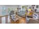 Relaxing living room with hardwood floors and access to a balcony at 7172 Dr Martin Luther King Jr S St, St Petersburg, FL 33705