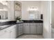 Bathroom with gray cabinets, dark granite countertops, and a corner sink at 7876 Marsh Pointe Dr, Tampa, FL 33635