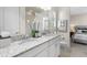 Double vanity bathroom with granite countertop and bedroom view at 7876 Marsh Pointe Dr, Tampa, FL 33635