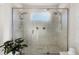 Large walk-in shower with marble tile and dual shower heads at 7876 Marsh Pointe Dr, Tampa, FL 33635