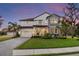 Two-story house with stone accents and a landscaped yard at 7876 Marsh Pointe Dr, Tampa, FL 33635