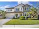 Stunning two-story house with stone accents and a beautifully landscaped yard at 7876 Marsh Pointe Dr, Tampa, FL 33635