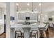 Modern kitchen with sleek cabinetry, expansive island, and high-end appliances at 7876 Marsh Pointe Dr, Tampa, FL 33635