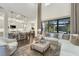 Open-concept living space with a sectional sofa, large windows, and kitchen views at 7876 Marsh Pointe Dr, Tampa, FL 33635
