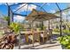 Spacious outdoor dining area with large patio umbrella and seating for eight at 7876 Marsh Pointe Dr, Tampa, FL 33635