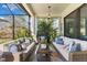 Cozy screened porch with wicker furniture, creating a relaxing outdoor space at 7876 Marsh Pointe Dr, Tampa, FL 33635