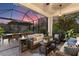 Evening view of a relaxing screened porch with seating and fire pit at 7876 Marsh Pointe Dr, Tampa, FL 33635