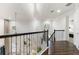 Upstairs hallway with dark wood flooring and an iron railing at 7876 Marsh Pointe Dr, Tampa, FL 33635
