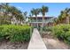 Elevated home with private dock leading to the water at 79 Palm Dr, Placida, FL 33946