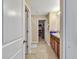 Well-lit bathroom with dual sinks, a shower, and walk-in closet at 8506 Hunters Fork Loop, Ruskin, FL 33573