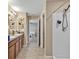 Clean bathroom with dual sinks, shower, and access to bedrooms at 8506 Hunters Fork Loop, Ruskin, FL 33573