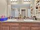Modern bathroom boasting dual vanities and granite countertops at 8506 Hunters Fork Loop, Ruskin, FL 33573