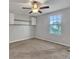Bright bedroom with ceiling fan, neutral walls, and carpeted floor at 8506 Hunters Fork Loop, Ruskin, FL 33573