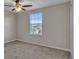 Bright bedroom with a window, ceiling fan, and carpeted floors at 8506 Hunters Fork Loop, Ruskin, FL 33573
