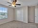 Well-lit bedroom with ceiling fan and double door closet at 8506 Hunters Fork Loop, Ruskin, FL 33573
