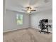 Bedroom with ceiling fan, neutral walls, carpeted floor, and a workspace at 8506 Hunters Fork Loop, Ruskin, FL 33573