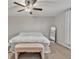 Spacious bedroom with a large bed, ceiling fan, and ample natural light at 8506 Hunters Fork Loop, Ruskin, FL 33573