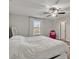 Comfortable bedroom with a large bed, ceiling fan, and access to a bathroom at 8506 Hunters Fork Loop, Ruskin, FL 33573