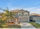 Two-story house with a two-car garage and landscaping at 8506 Hunters Fork Loop, Ruskin, FL 33573