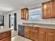 Kitchen with wood cabinets, granite countertops, and a view of the backyard at 8506 Hunters Fork Loop, Ruskin, FL 33573
