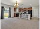 Kitchen with island, dark cabinets, and granite countertops at 8506 Hunters Fork Loop, Ruskin, FL 33573
