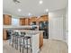 Eat-in kitchen with island, wood cabinets, and black appliances at 8506 Hunters Fork Loop, Ruskin, FL 33573