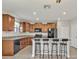 Kitchen with island, dark cabinets, and granite countertops at 8506 Hunters Fork Loop, Ruskin, FL 33573