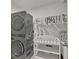Laundry room with stacked washer and dryer, and a changing table at 8506 Hunters Fork Loop, Ruskin, FL 33573