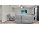 Living room with grey reclining sofas and a ceiling fan at 8506 Hunters Fork Loop, Ruskin, FL 33573