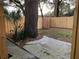 Small backyard with a wooden fence and a large tree at 8537 Cameo Dr, New Port Richey, FL 34654