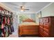 Bedroom with large closet, ceiling fan, wood framed bed, and dresser at 8537 Cameo Dr, New Port Richey, FL 34654