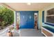 Inviting entryway with double blue doors and a cozy porch at 8537 Cameo Dr, New Port Richey, FL 34654
