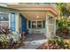 Inviting front porch with blue door and decorative planters at 8537 Cameo Dr, New Port Richey, FL 34654