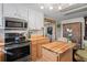 Updated kitchen featuring butcher block island and stainless steel appliances at 8537 Cameo Dr, New Port Richey, FL 34654