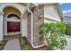 Close up view of a single Gathering home's brick accents, front door and well-maintained landscaping at 9010 Quail Creek Dr, Tampa, FL 33647