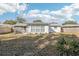 Large backyard with a grassy area and screened patio at 10904 90Th Ter, Seminole, FL 33772