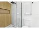 Contemporary bathroom with a wood-look shower wall and glass enclosure at 10904 90Th Ter, Seminole, FL 33772