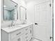 Modern bathroom featuring double sinks and white cabinetry at 10904 90Th Ter, Seminole, FL 33772