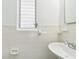 Small bathroom with a sink and white tile at 10904 90Th Ter, Seminole, FL 33772