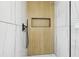 Modern bathroom with a wood-look shower wall and glass enclosure at 10904 90Th Ter, Seminole, FL 33772