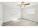 Bedroom with vinyl plank flooring and ceiling fan at 10904 90Th Ter, Seminole, FL 33772