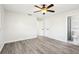 Spacious bedroom with grey wood-look floors and en-suite bathroom at 10904 90Th Ter, Seminole, FL 33772