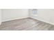 Empty bedroom with gray vinyl plank flooring and window at 10904 90Th Ter, Seminole, FL 33772