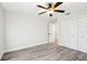 Bedroom with vinyl plank flooring, ceiling fan and double door closet at 10904 90Th Ter, Seminole, FL 33772