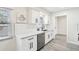 Modern kitchen with white cabinets, quartz countertops and stainless steel appliances at 10904 90Th Ter, Seminole, FL 33772
