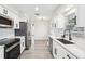 Modern kitchen with stainless steel appliances and white cabinets at 10904 90Th Ter, Seminole, FL 33772